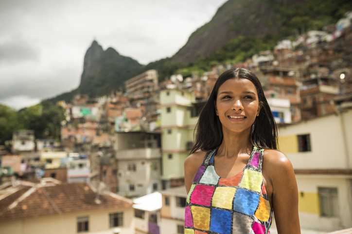 A woman in Brazil smiles while looking off camera