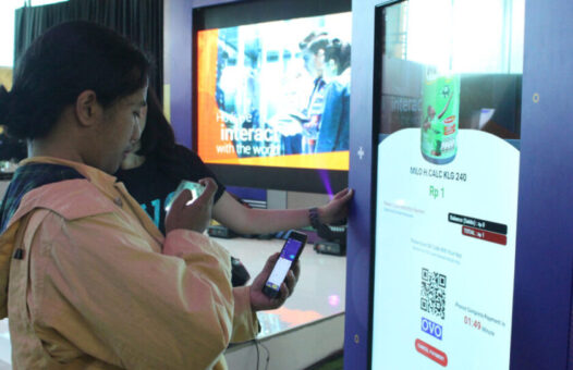 A woman at a OVO SmartCube Vending Machine in Indonesia