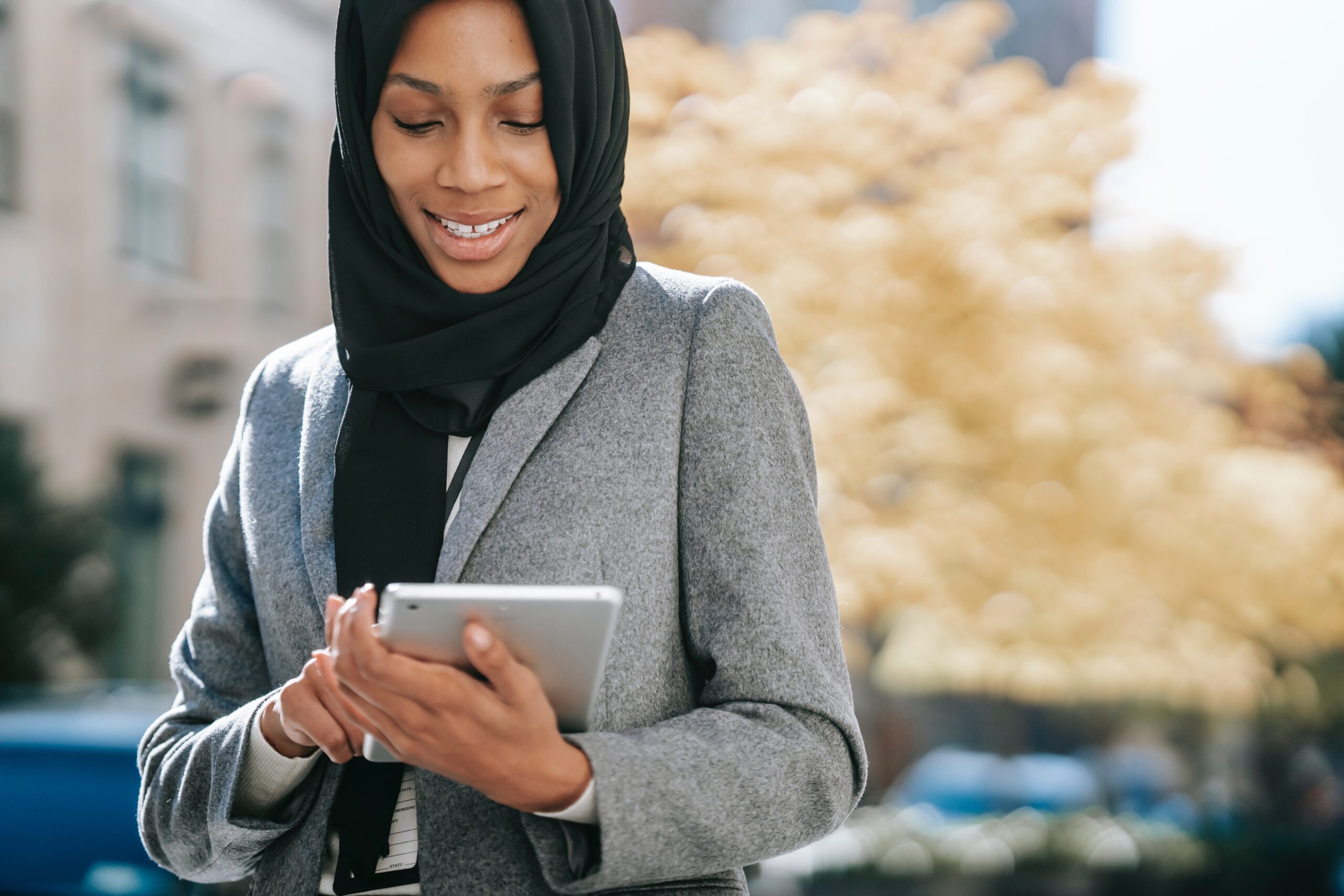 Business woman in hijab uses ipad