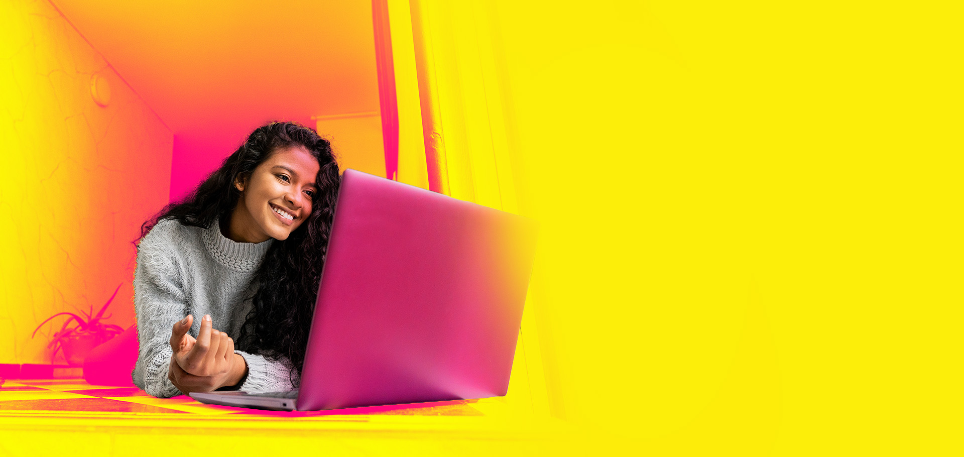 Happy female student at her computer depicting educational payment case study