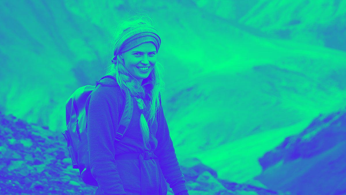 Hiker standing on rocky hillside depicting Iceland Payment Method