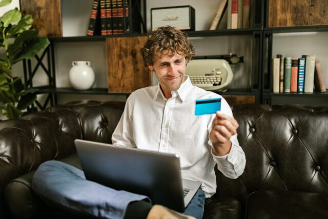 man shopping online with credit card