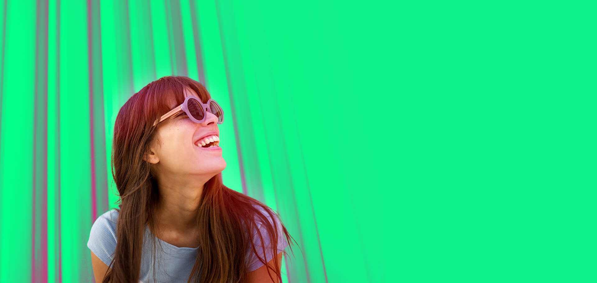 Close up cheerful young woman laughing with sunglasses against colourful background depicting Virtual Account