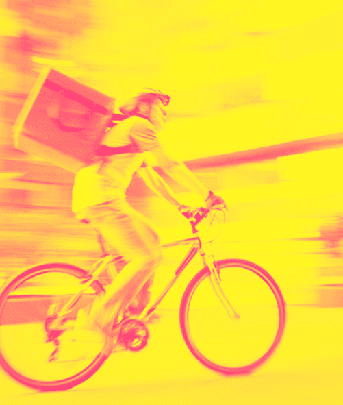 A man delivers groceries on a bike representing gig economy payments solutions.