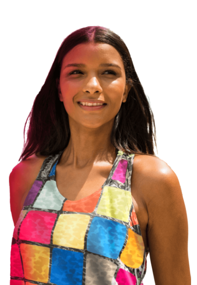 A woman in Brazil standing on a hillside, wearing a multi-colored shirt, representing cross-border payments