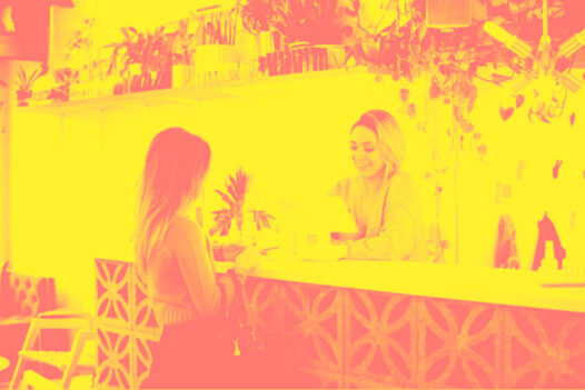 A woman talks to concierge at hotel front desk