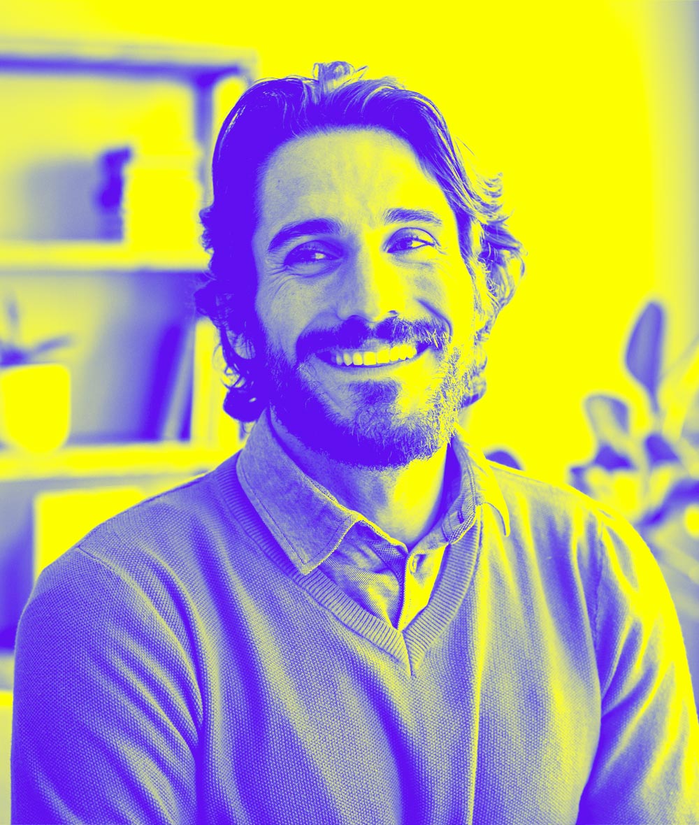 A guy in a polo shirt is smiling.