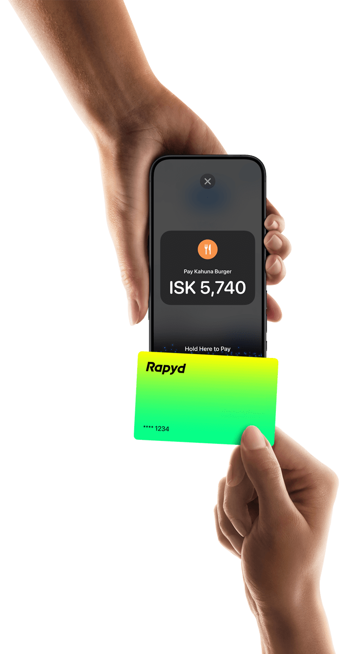 A hand holds a Rapyd credit card and uses tap to pay technology.